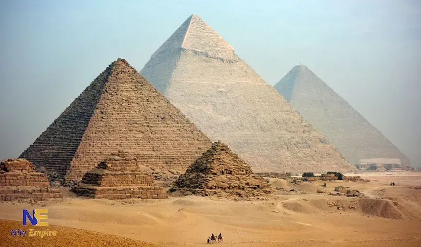 The three Giza pyramids with camel riders in the foreground